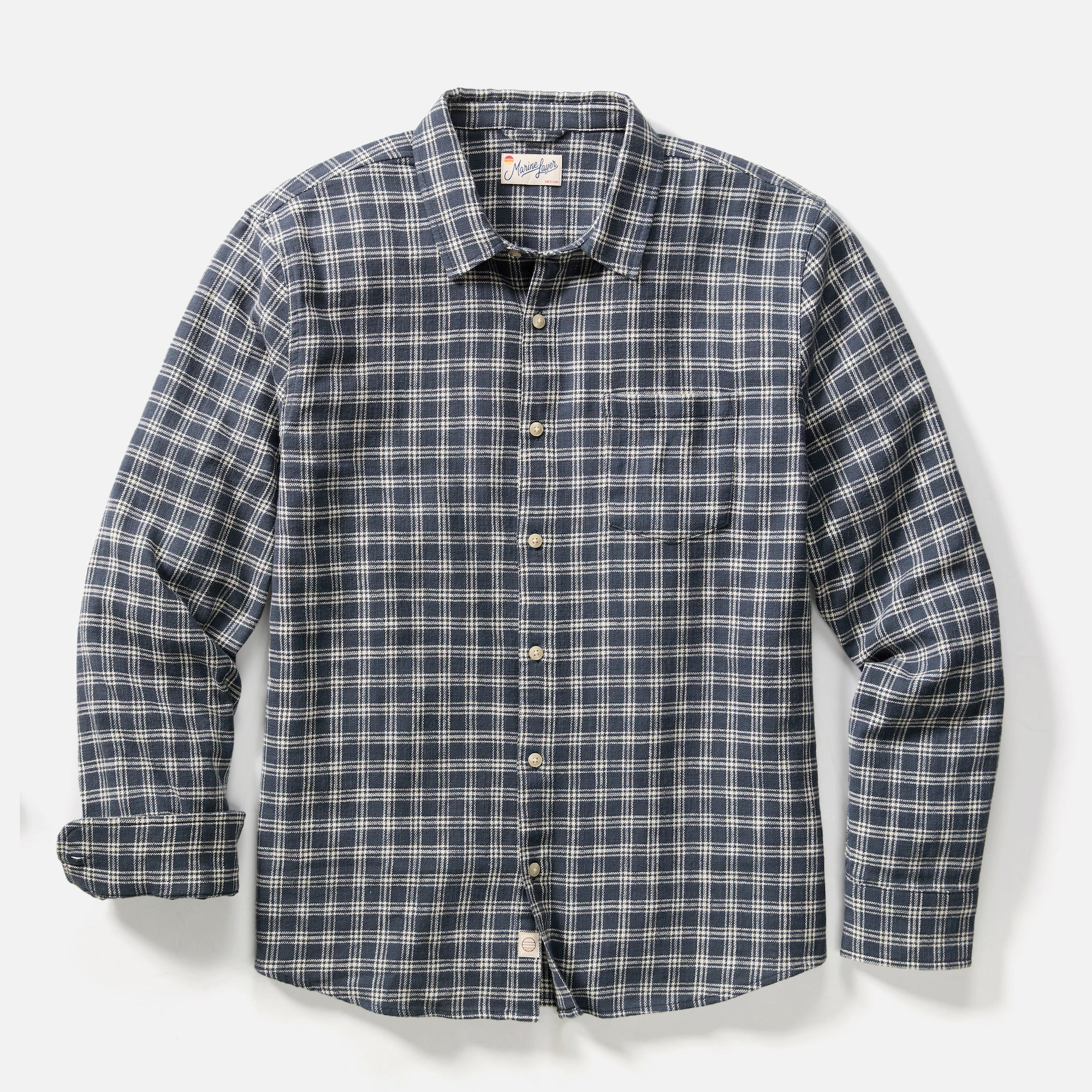 Plaid shirt with button details on a light gray background