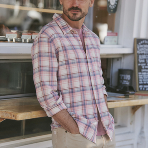 Man wearing a plaid shirt in a casual setting