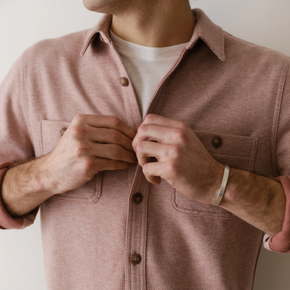 Person wearing a pink jacket with a neutral background