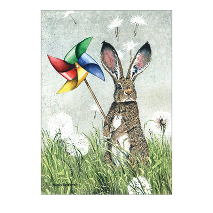 rabbit with pinwheel in grass