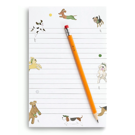 Notepad with dog illustrations and a pencil on a white background