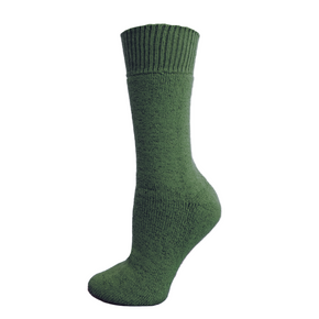 Green sock on a wooden block with a white background