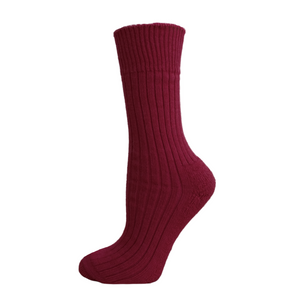Maroon sock on a wooden platform with a white background
