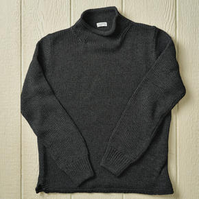 Charcoal grey sweater on a neutral background.