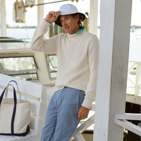 Man wearing a blue sweater and blue pants.