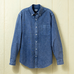 Blue button down shirt on a neutral background.