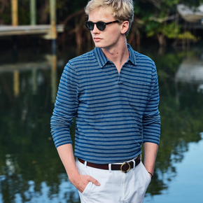 Man wearing a blue striped long sleeve polo.