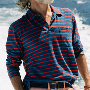 Man wearing blue and red striped long sleeve polo.