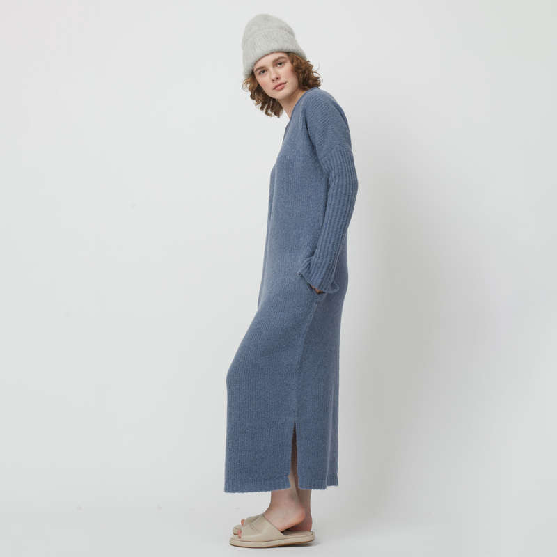 Atelier Delphine Relaxed V-Neck Dress - model wearing slate blue knit dress with pockets on neutral background