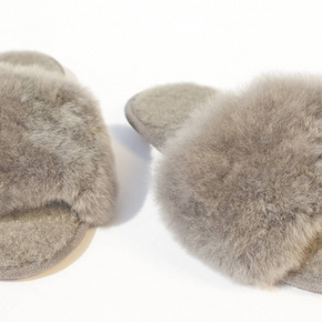 Pair of fluffy slippers on a white background