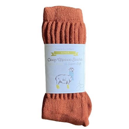 Pair of orange socks with a label on a white background