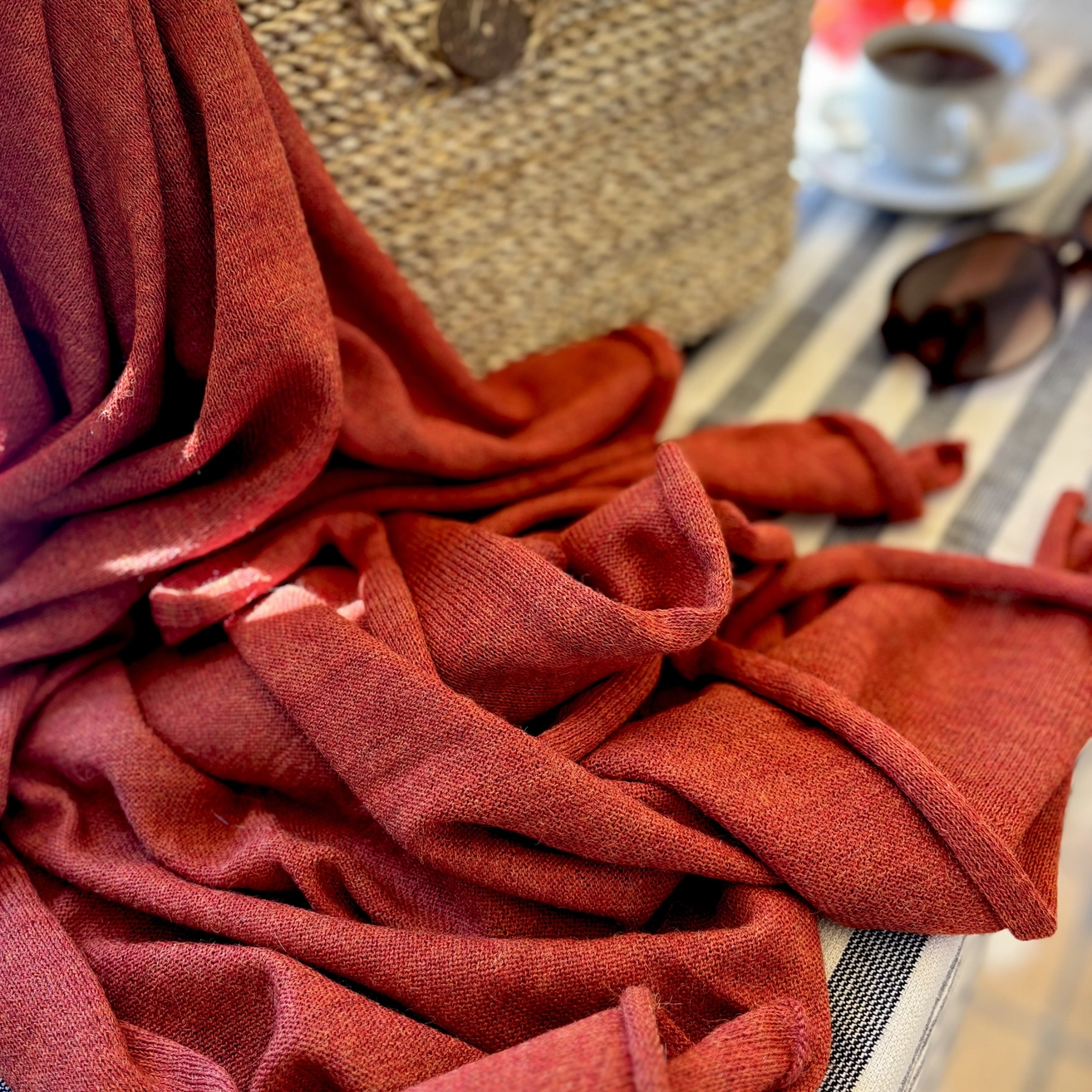 Red-orange wrap draped over a surface with a blurred background