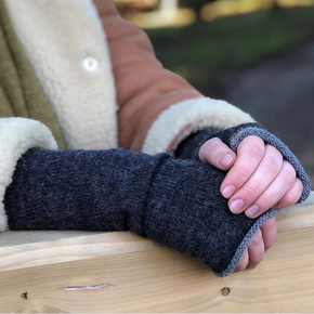 Person wearing a dark gray wrist warmers