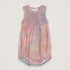 Baby romper with tie-dye pattern on a light gray background