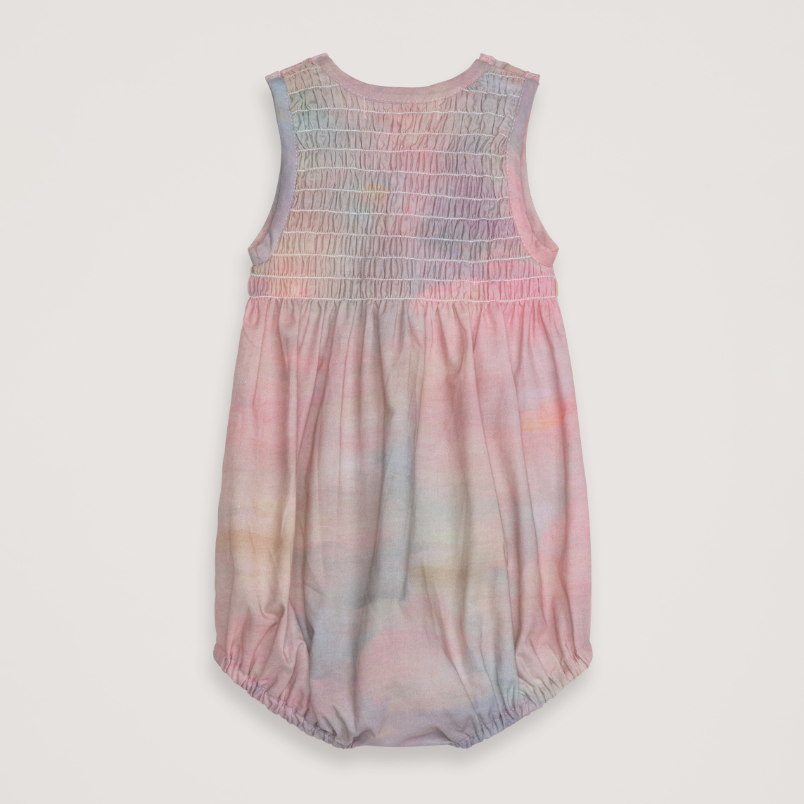 Pastel tie-dye baby romper on a light gray background
