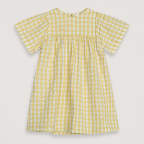 Yellow checkered dress on a light gray background