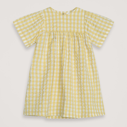 Yellow checkered dress on a light gray background