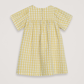 Yellow checkered dress on a light gray background