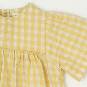Yellow and white checkered dress on a white background