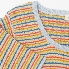 Close-up of a colorful striped top with a brand label.