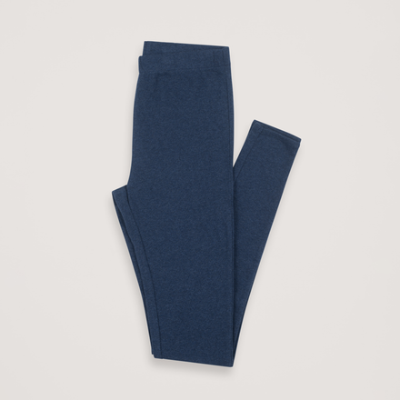 Pair of blue leggings folded on a light gray background