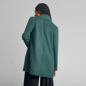 Kuna Short Swing Coat - model wearing green coat on a neutral background