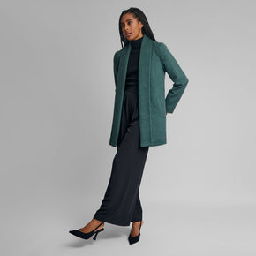 Kuna Short Swing Coat - model wearing green coat with full length lapels on a neutral background