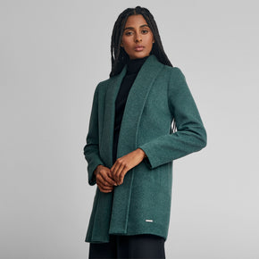 Kuna Short Swing Coat - model wearing green coat with full length lapels on a neutral background