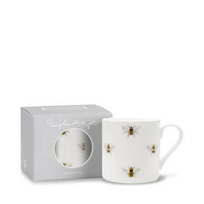 White mug with a bee pattern and gift box