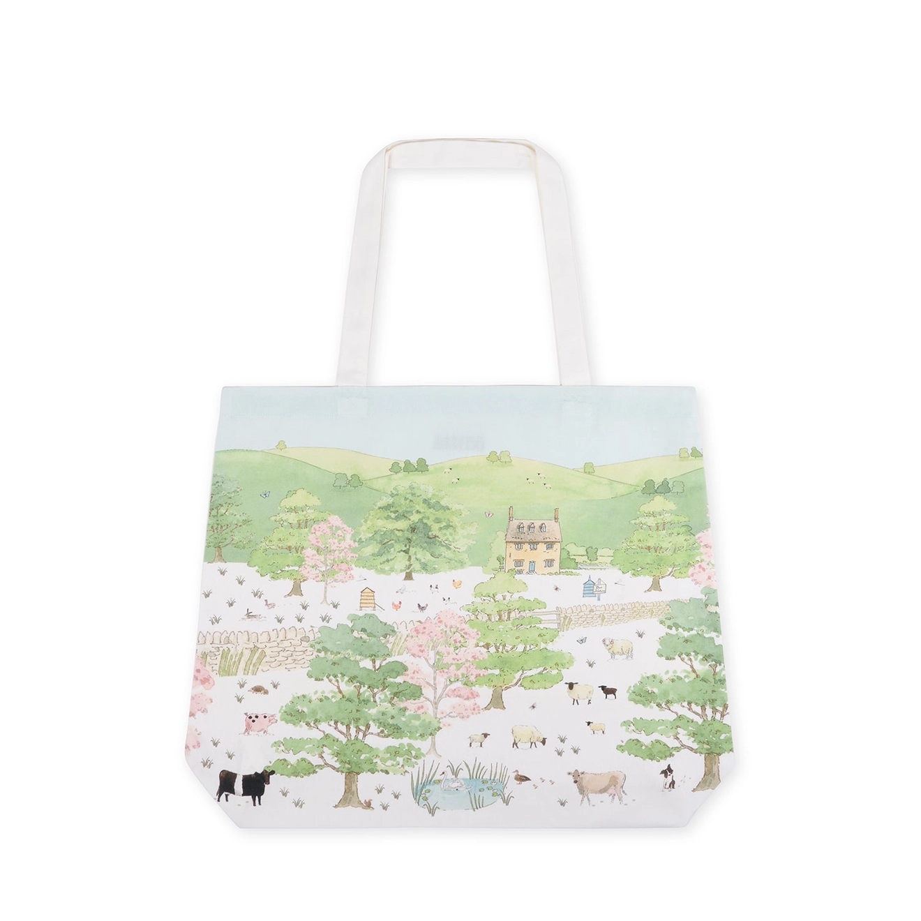 Tote bag with a scenic landscape design featuring trees, houses, and animals on a white background.