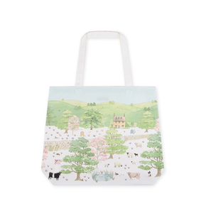 Tote bag with a scenic landscape design featuring trees, houses, and animals on a white background.