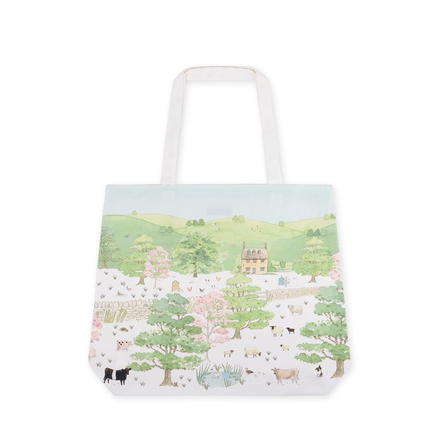 Tote bag with a scenic landscape design featuring trees, houses, and animals on a white background.
