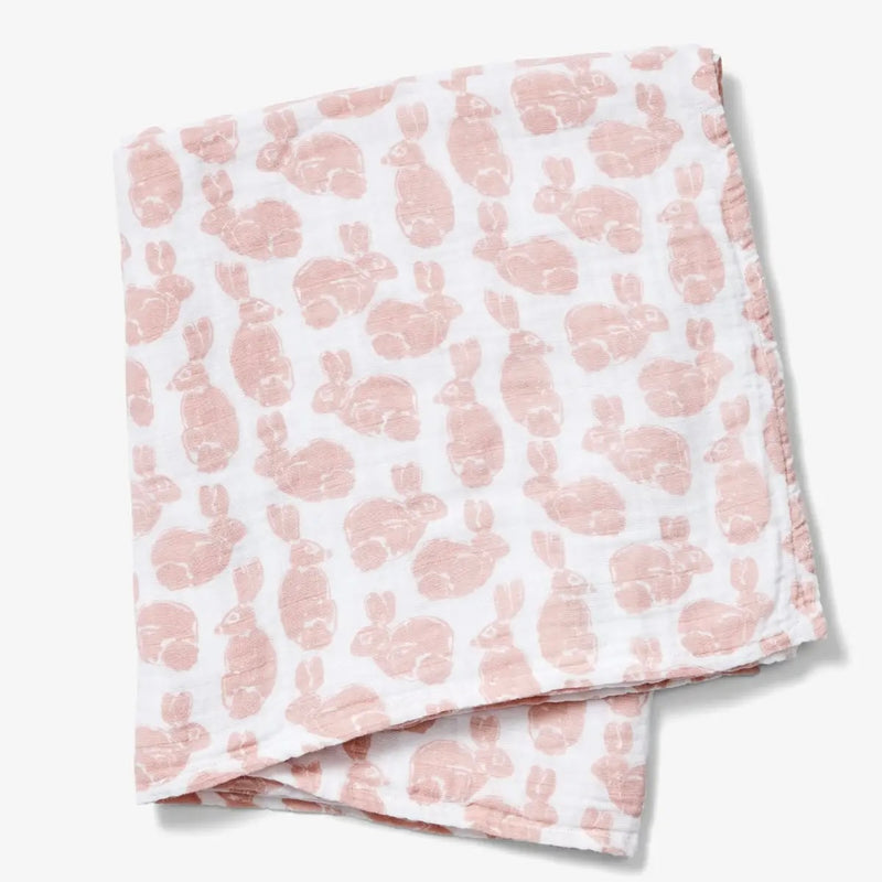 Baby Swaddle - white baby swaddle with light pink bunny print on a neutral background
