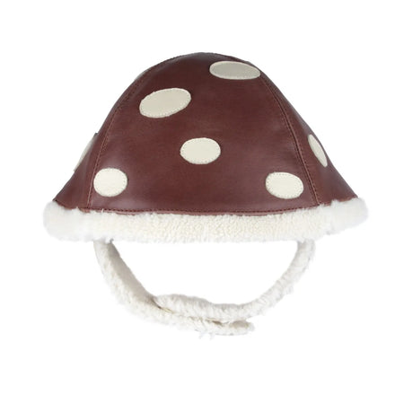 Donsje Toadstool Wilder Hat - red and white leather toadstool cap with faux fur lining and velcro strap on a neutral background