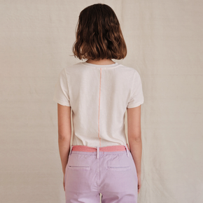 Sundry Vivre Boy Tee - model wearing white t-shirt with with pink stitching down the back on a neutral background