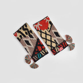 Kuna Watanabe Alpaca Gloves - yellow, black, red, and blue patterned gloves with pom pom detail on a neutral background