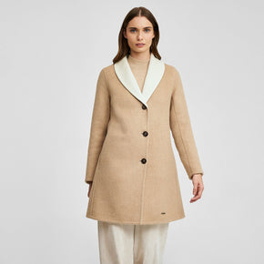 Kuna Willianne Coat - model wearing tan coat with white lining and black buttons on a neutral background