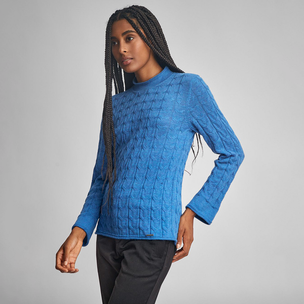 Kuna Willow Sweater - model wearing blue mock turtle neck sweater with cabling on a neutral background
