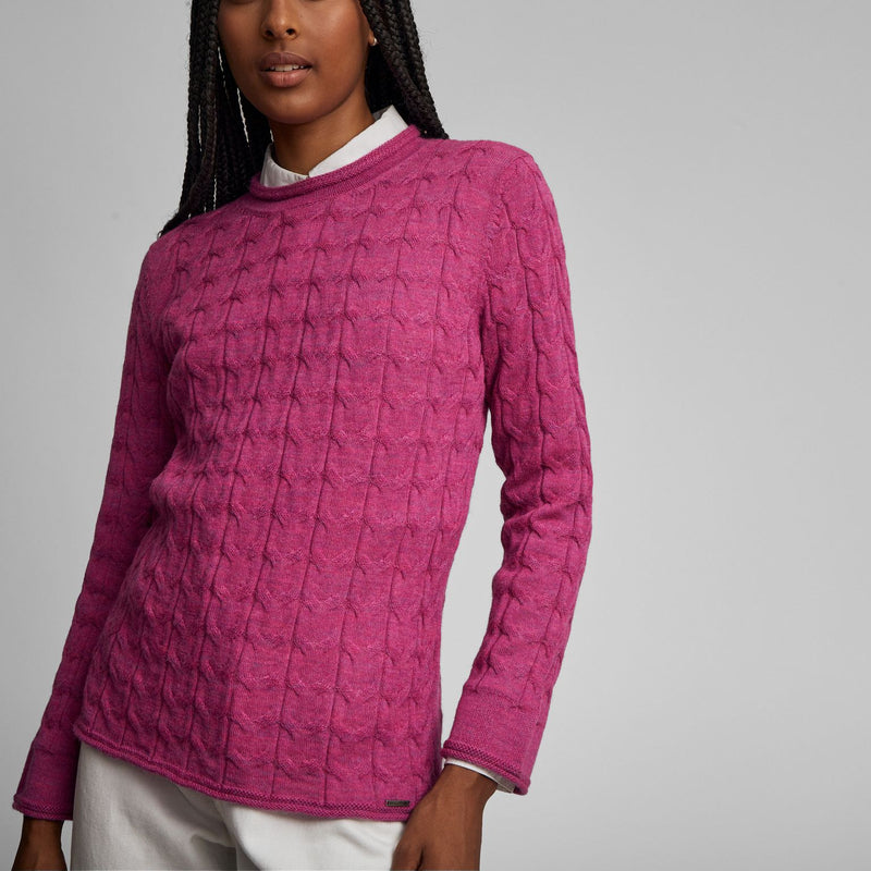 Kuna Willow Sweater - model wearing pink mock turtle neck sweater with cabling on a neutral background