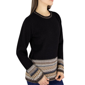 Black sweater with patterned cuffs and hem on a white background