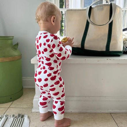 Babies' Zip Sleeper - baby wearing white zip onesie with a red apple pattern