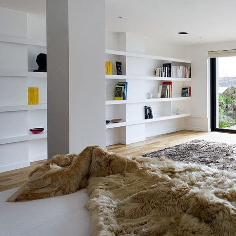 Samantha Holmes Alpaca Fur Throw - Cruelty-Free, the end of a bed with a beige fur throw on the end\