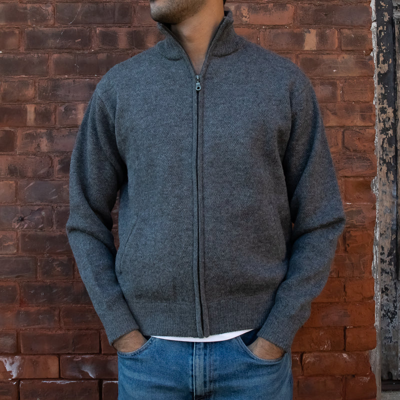 Men's Heavyweight Full-Zip 100% Baby Alpaca Wool Jacket, a aman wearing a baby alpaca full zippered jacket stands in front of a brick wall