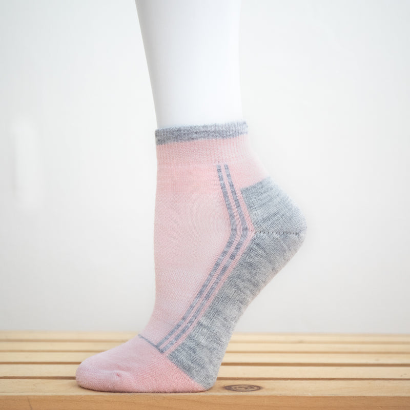Alpaca Running  and Athletic Ankle Socks. A pair of light pink alpaca ankle running socks in front of a white background. 