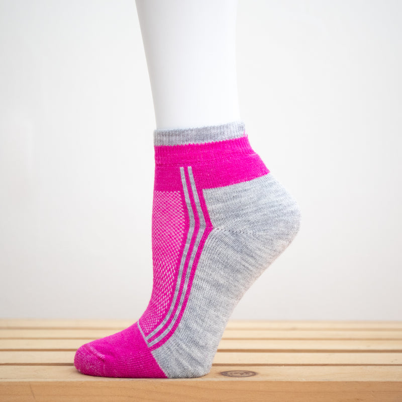 Alpaca Running  and Athletic Ankle Socks. A pair of fucshia alpaca ankle running socks in front of a white background. 