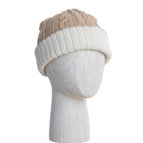 Two-tone knit beanie on a mannequin head against a light wooden panel background