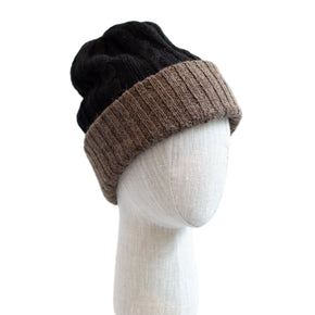 Two-toned black and brown beanie on a mannequin head against a white background
