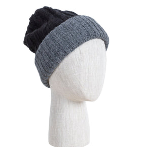 Two-toned black and gray knit beanie on a mannequin head against a white background