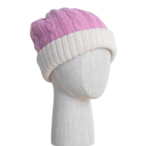 Two-toned knit beanie on a mannequin head against a white wooden panel background