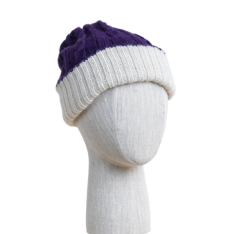 Two-toned purple and white knit beanie on a mannequin head against a white background